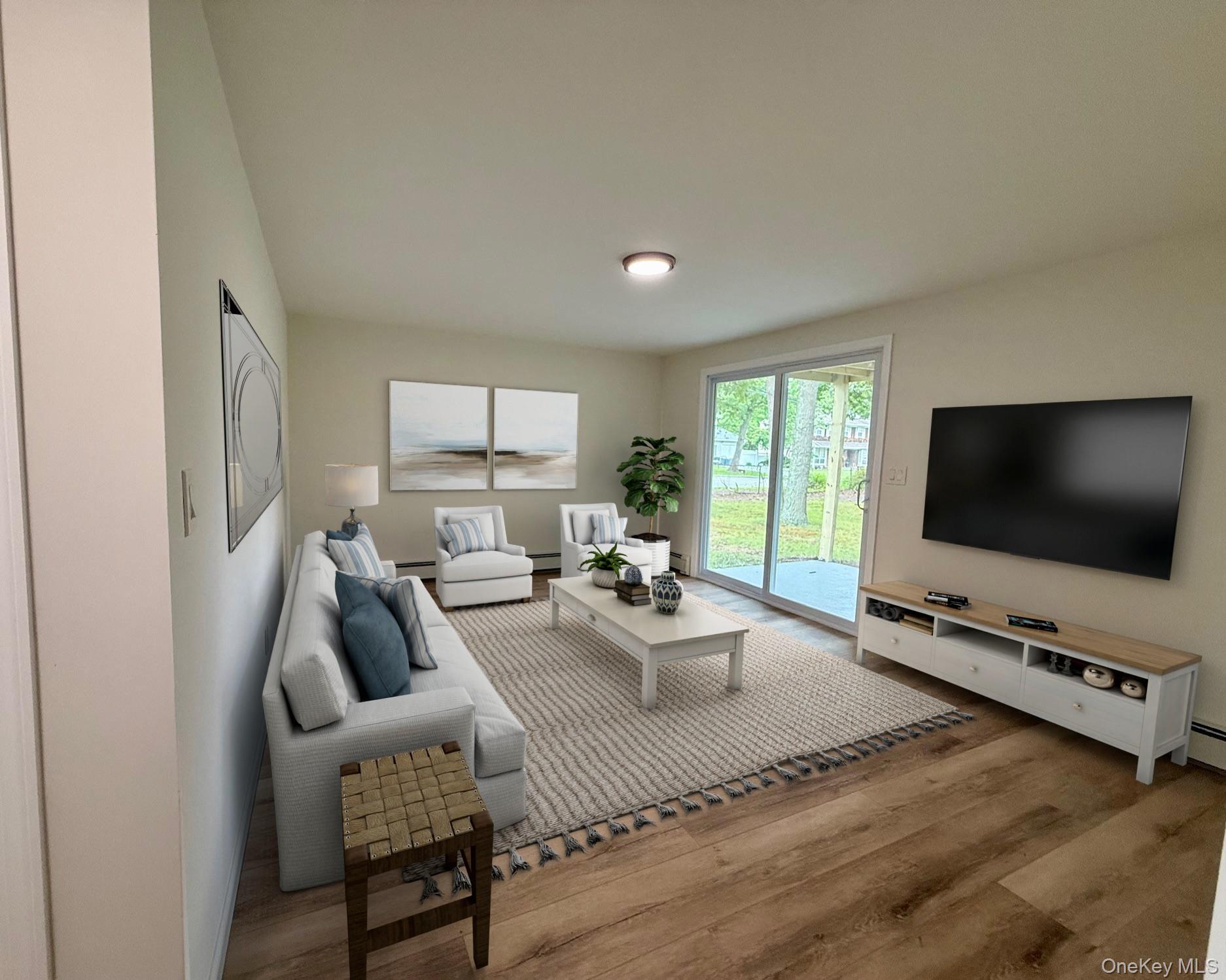 30 7th Street Holbrook, NY 11741 - Photo 18 of 22 a living room with furniture a flat screen tv and a large window