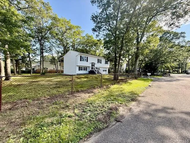 a view of a house with swimming pool and trees in the background