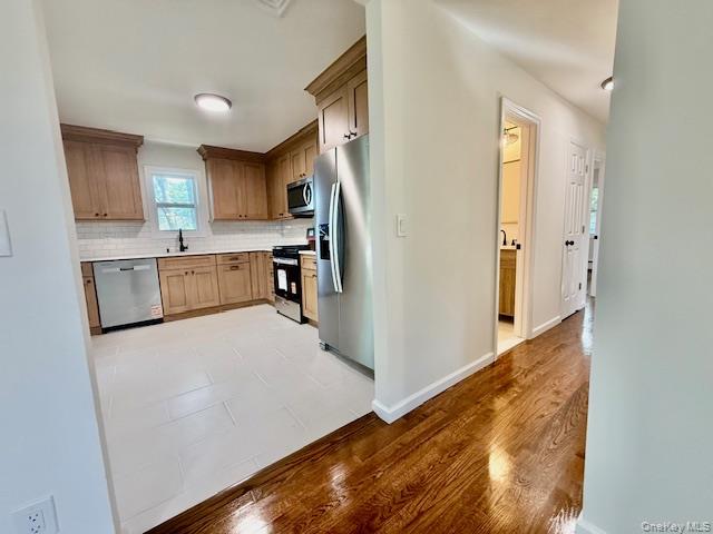 30 7th Street Holbrook, NY 11741 - Photo 8 of 22 a kitchen with cabinets and wooden floor