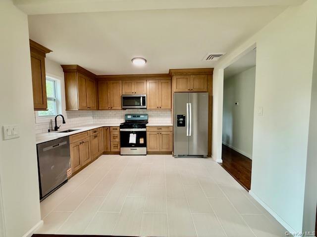 30 7th Street Holbrook, NY 11741 - Photo 9 of 22 a large kitchen with cabinets and stainless steel appliances