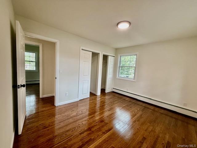 30 7th Street Holbrook, NY 11741 - Photo 10 of 22 an empty room with wooden floor and windows