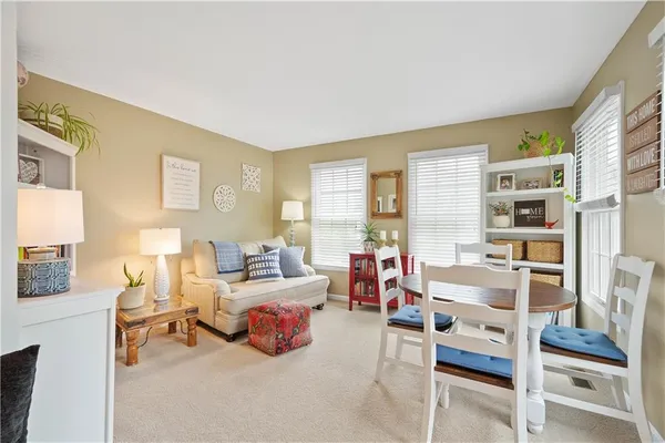 a bedroom with furniture and a large window
