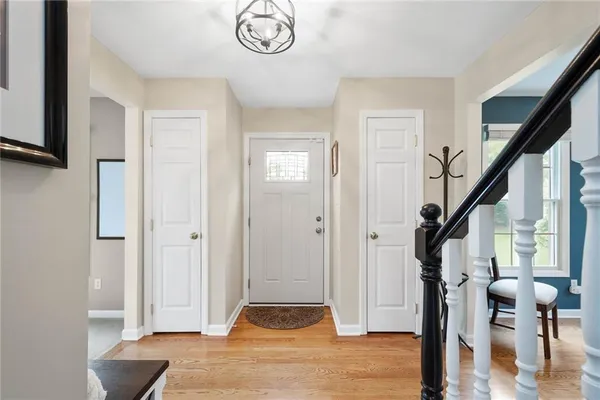 a view of entryway with wooden floor and stairs