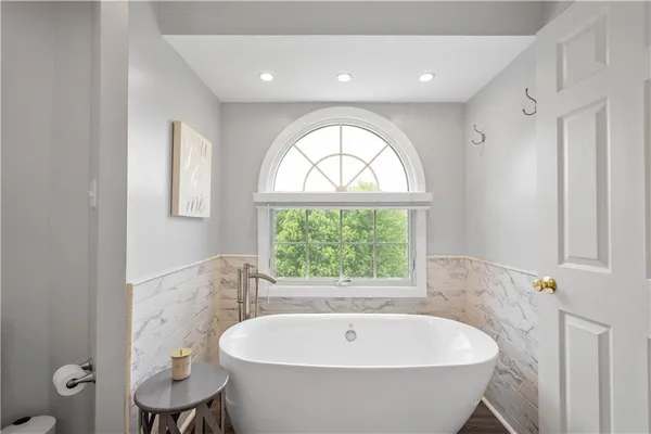 a bath tub sitting next to a window