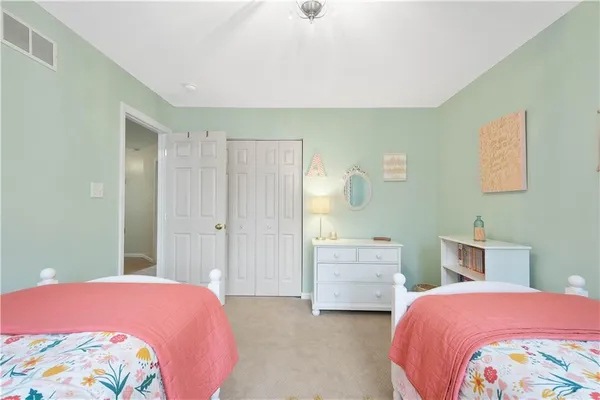 a bedroom with a bed and dresser