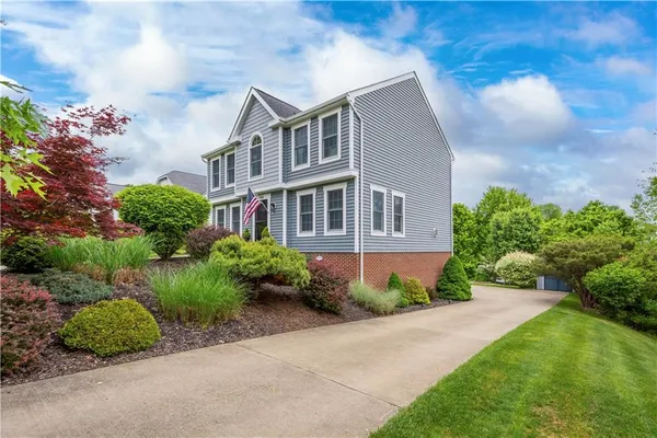 a view of backyard with deck and garden