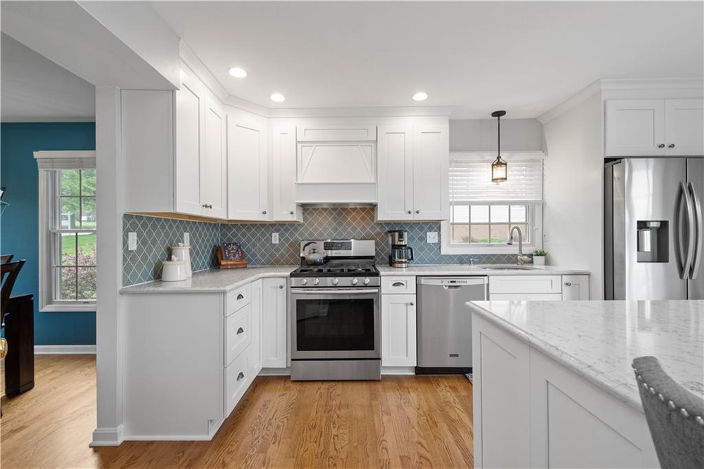 108 Walnut Drive Eighty Four, PA 15330 - Photo 4 of 47 a kitchen with stainless steel appliances granite countertop a stove a sink and a refrigerator