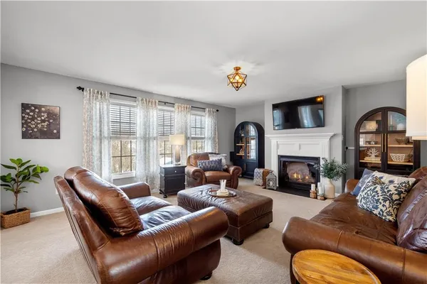 a living room with furniture fireplace and a flat screen tv