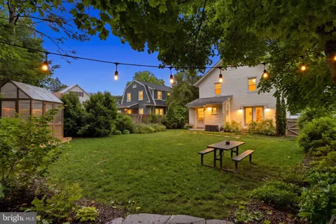 a backyard of a house with yard and outdoor seating
