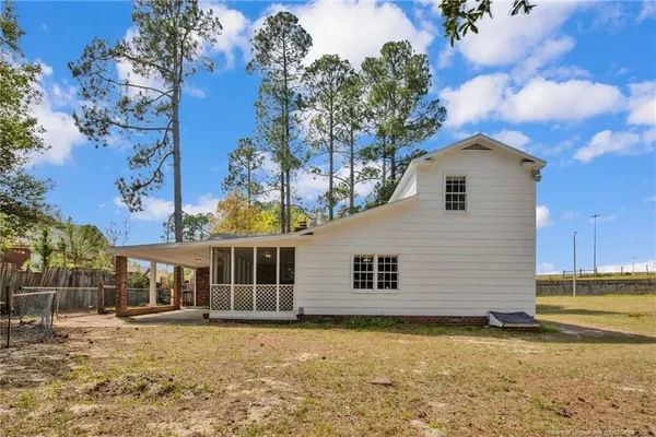a view of a house with a backyard