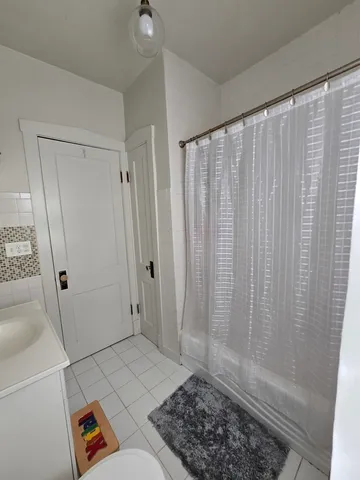 a view of a bathroom with shower and bathtub