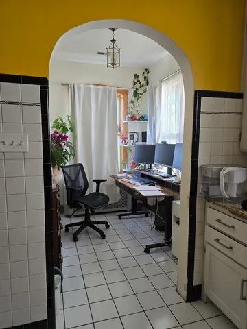 a view of a workspace with furniture and a potted plant