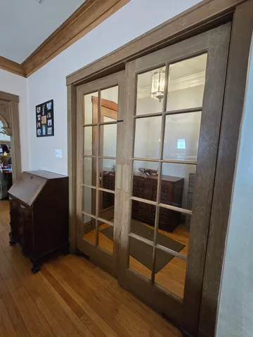 a living room with wooden floor and a window