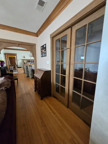 a living room with furniture a flat screen tv and entryway