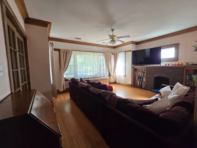 a living room with furniture a fireplace and a flat screen tv