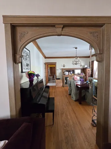 a living room with furniture and a chandelier