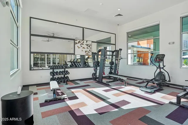 a room with gym equipment and a rug