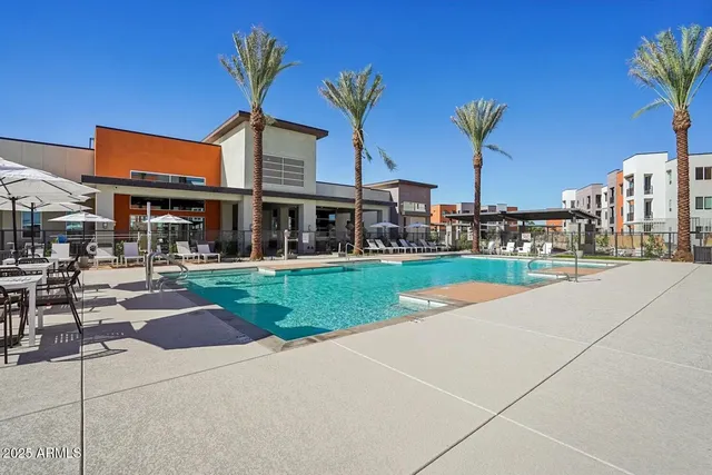 a view of a building with a yard and sitting area
