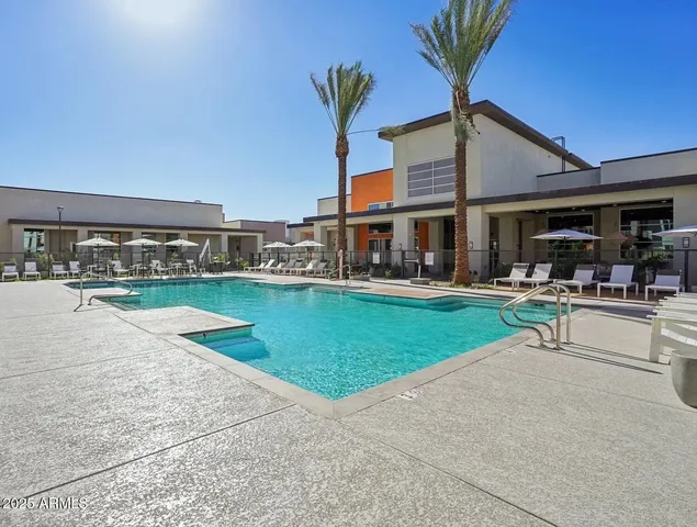 a view of a swimming pool with a table and chairs