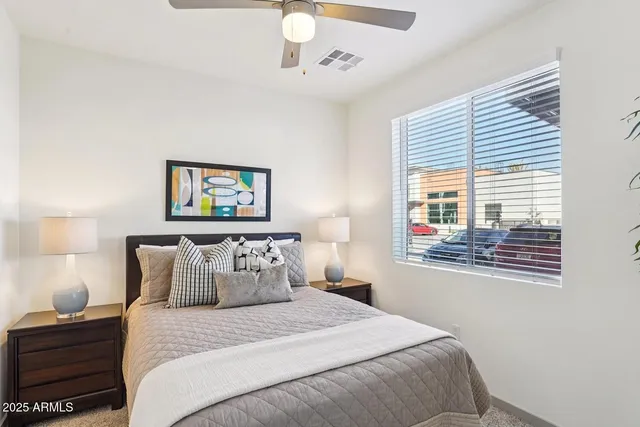 a bedroom with a bed and a window