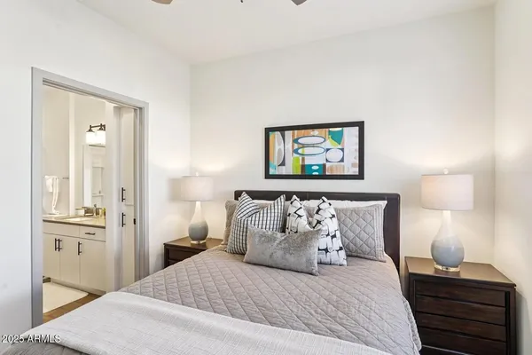 a bedroom with a bed and a painting on the wall