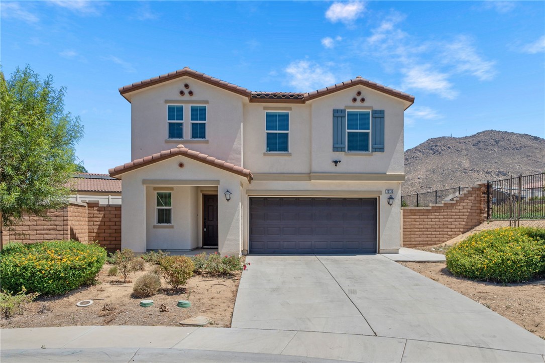 20130 Curaco Court Riverside, CA 92507 - Photo 9 of 43 Front exterior with covered porch, two-car garage, and mountain views.