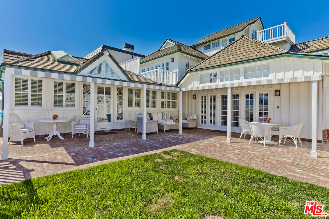 23430 Malibu Colony Road, Unit 95 Malibu, CA 90265 - Photo 11 of 35 front view of a house with a yard and porch