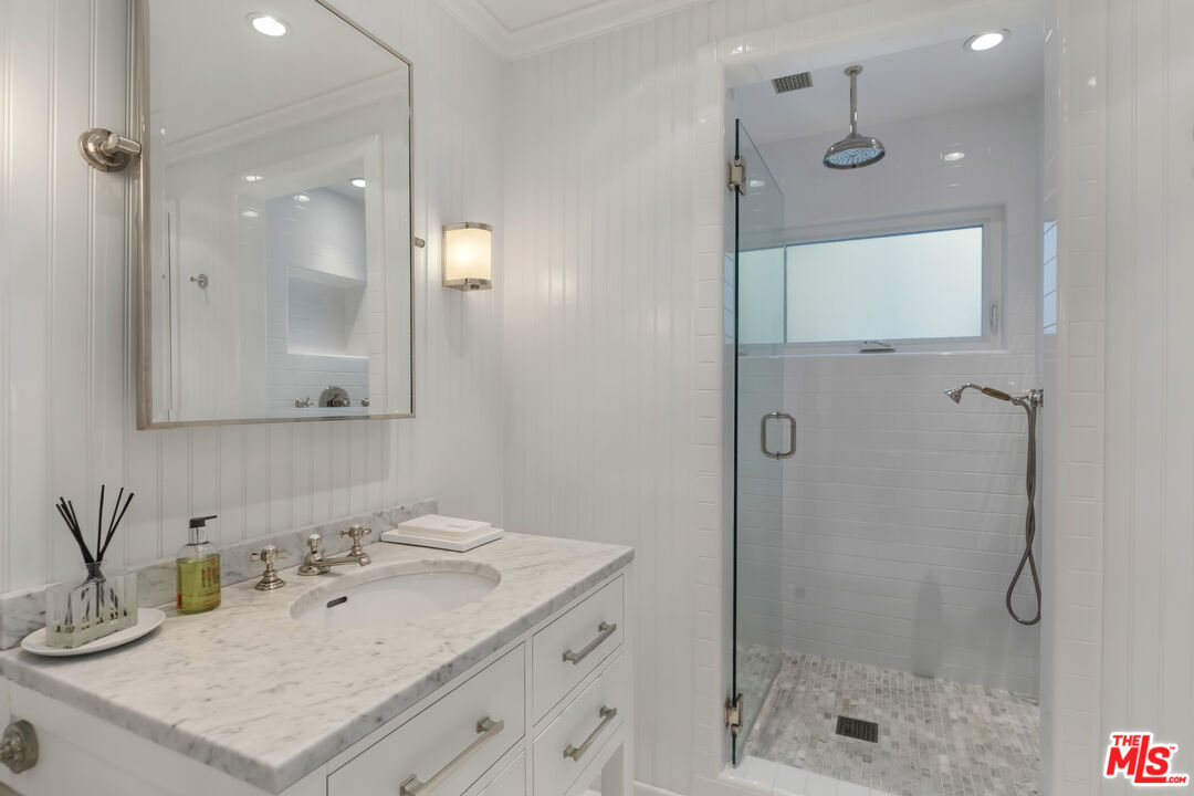 23430 Malibu Colony Road, Unit 95 Malibu, CA 90265 - Photo 21 of 35 a bathroom with a sink vanity granite shower and a mirror