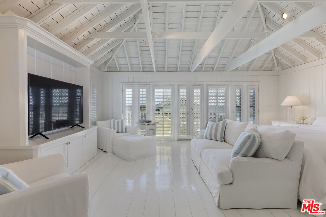 23430 Malibu Colony Road, Unit 95 Malibu, CA 90265 - Photo 25 of 35 a living room with furniture and a flat screen tv