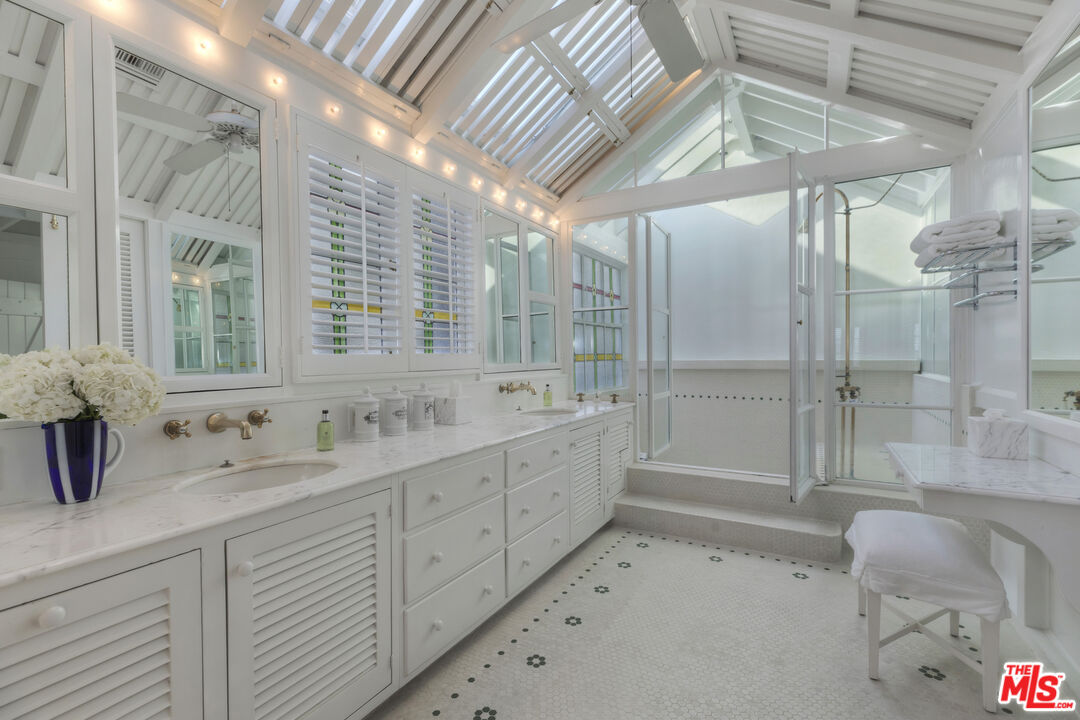 23430 Malibu Colony Road, Unit 95 Malibu, CA 90265 - Photo 27 of 35 a bathroom with double vanity and a shower
