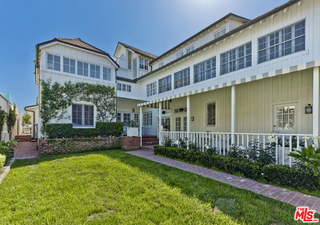 23430 Malibu Colony Road, Unit 95 Malibu, CA 90265 - Photo 4 of 35 a view of a brick building next to a yard