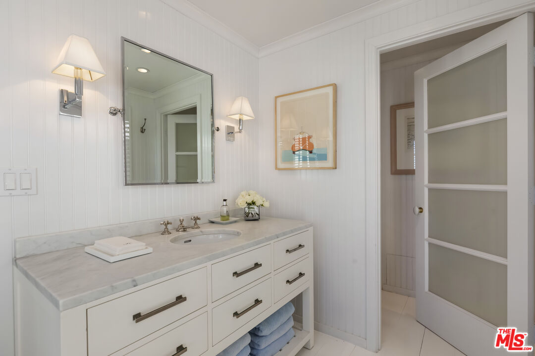 23430 Malibu Colony Road, Unit 95 Malibu, CA 90265 - Photo 7 of 35 a bathroom with a sink vanity and mirror