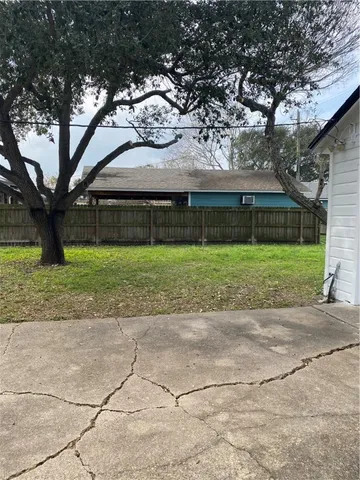 a house that has a tree in front of it