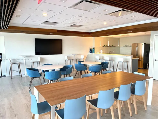 a roof deck with a table and chairs