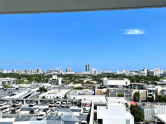 a view of a kitchen with a sink and a refrigerator