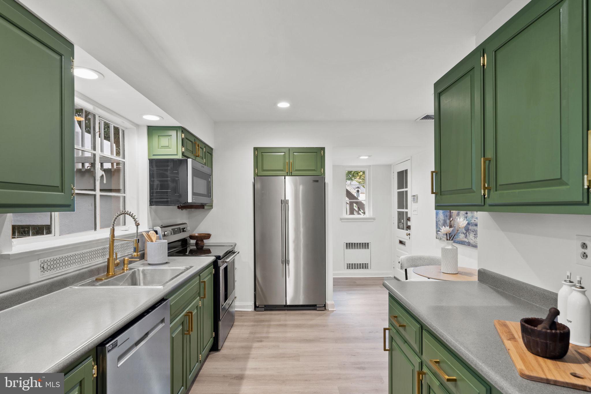 3937 Netherfield Road Philadelphia, PA 19129 - Photo 34 of 84 a kitchen with a sink stove top oven and refrigerator