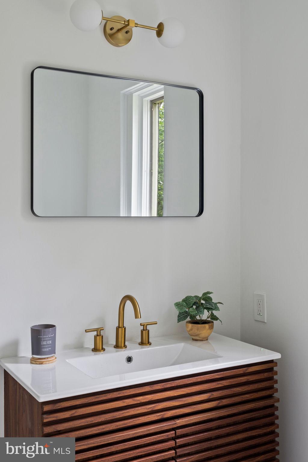 3937 Netherfield Road Philadelphia, PA 19129 - Photo 55 of 84 a bathroom with a sink and a mirror