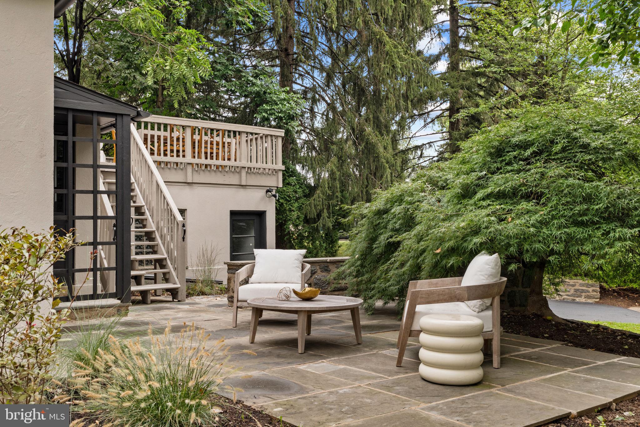 3937 Netherfield Road Philadelphia, PA 19129 - Photo 65 of 84 a view of a patio with couches table and chairs and potted plants