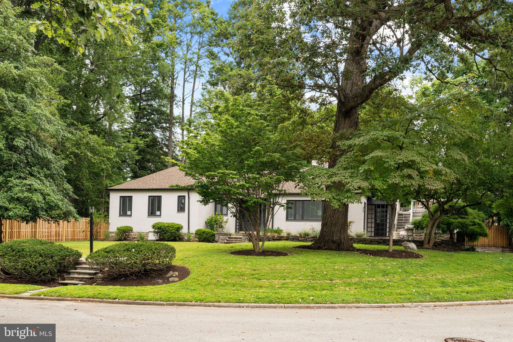 3937 Netherfield Road Philadelphia, PA 19129 - Photo 83 of 84 a front view of a house with a garden and trees