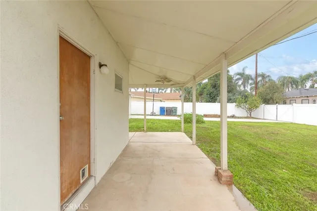 a view of a porch with wooden floor and a yard