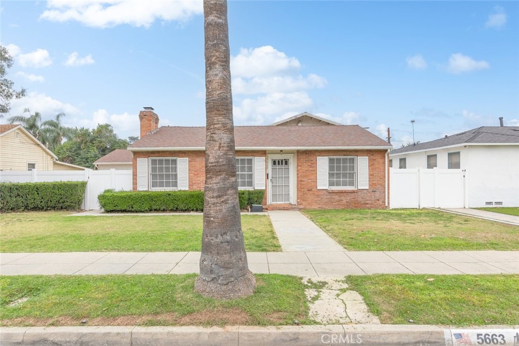 5663 Osburn Place Riverside, CA 92506 - Photo 3 of 38 a front view of a house with a garden and yard