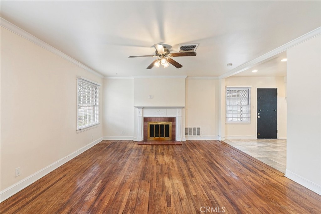 5663 Osburn Place Riverside, CA 92506 - Photo 7 of 38 a view of a livingroom with a fireplace a ceiling fan and fan