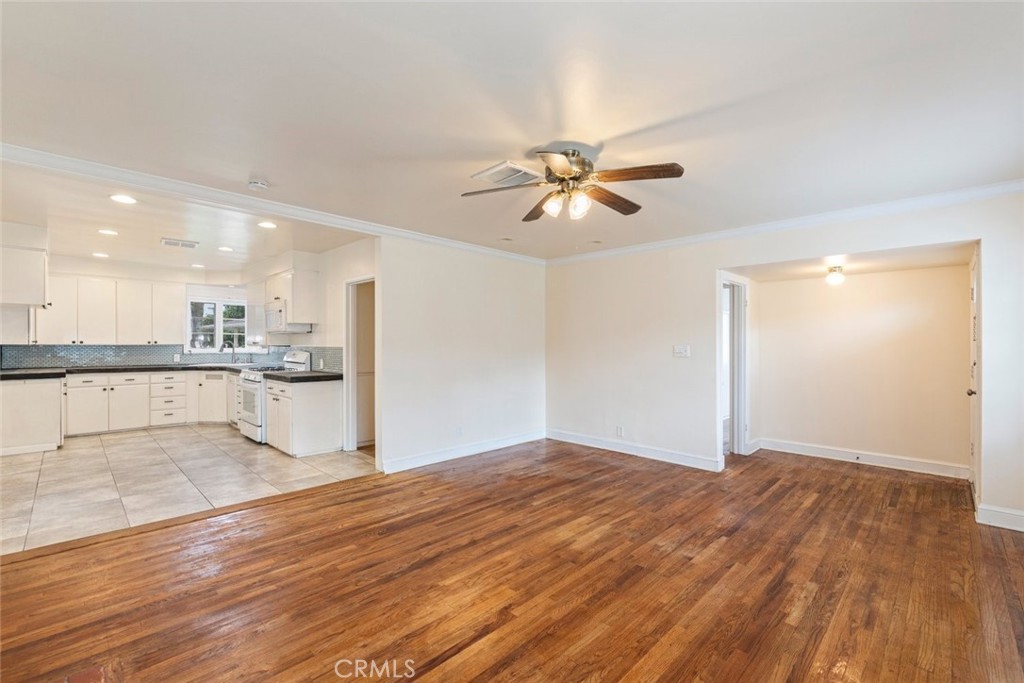 5663 Osburn Place Riverside, CA 92506 - Photo 8 of 38 a view of a big room with wooden floor and a kitchen