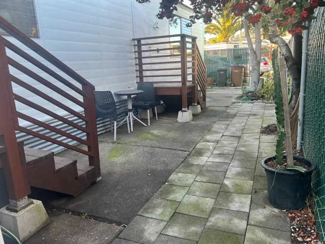 a view of a patio with table and chairs and potted plants
