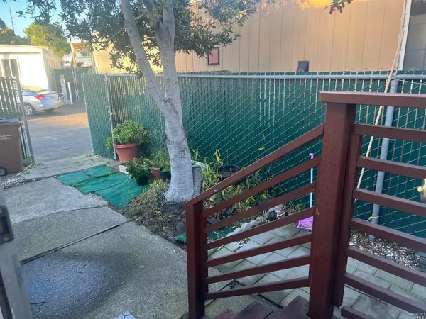 a view of a wooden fence and a pathway