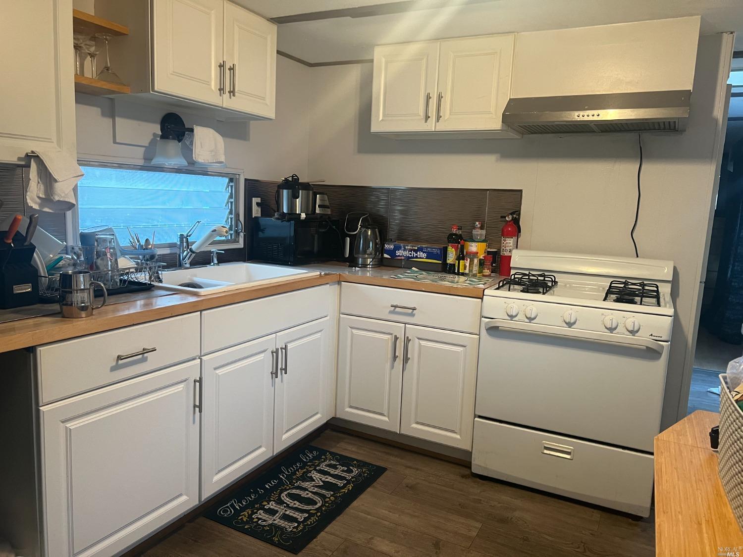 2130 Redwood Highway, Unit F5 Greenbrae, CA 94904 - Photo 4 of 20 a kitchen with cabinets stainless steel appliances and sink