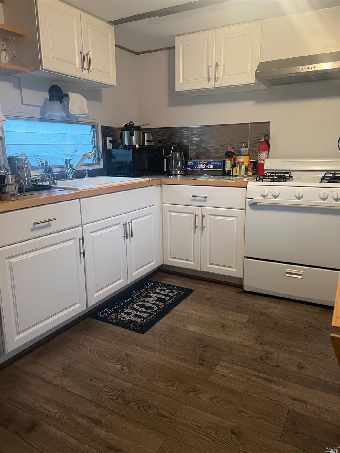 2130 Redwood Highway, Unit F5 Greenbrae, CA 94904 - Photo 5 of 20 a kitchen with white cabinets and white appliances