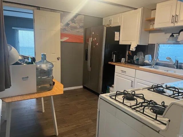 a kitchen with stainless steel appliances granite countertop a stove and a refrigerator