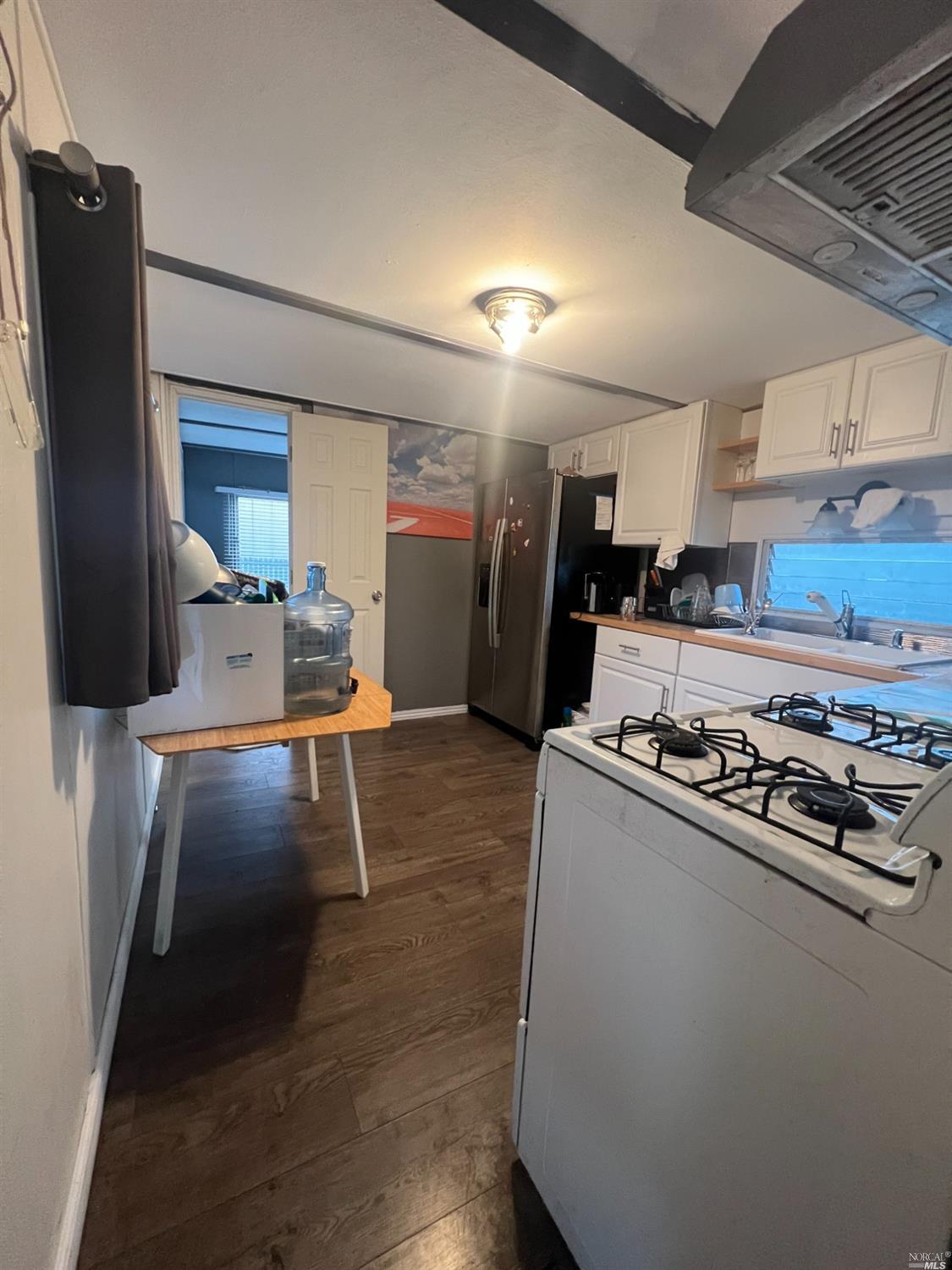 2130 Redwood Highway, Unit F5 Greenbrae, CA 94904 - Photo 7 of 20 a kitchen with kitchen island a counter top space and a refrigerator