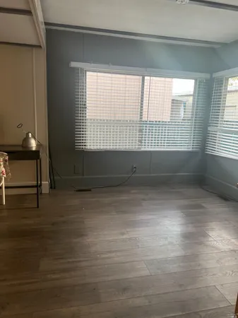 a view of room with window and hardwood floor
